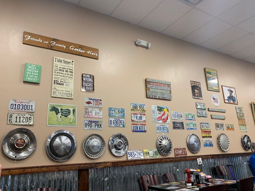 Dining room wall of hubcaps, license plates and country signs